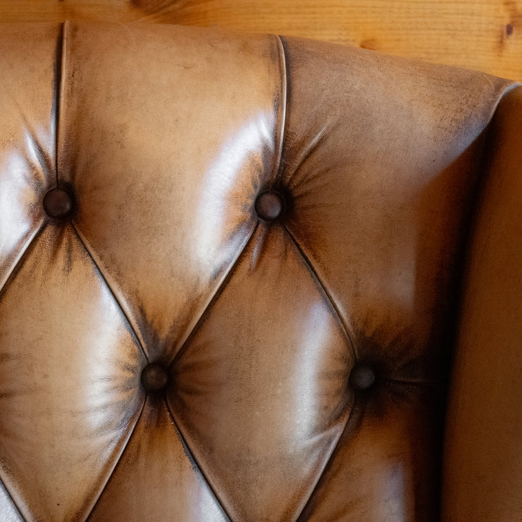 Buffalo Leather Tufted Wing Back Chair with Nailhead Trim, Angled Back View