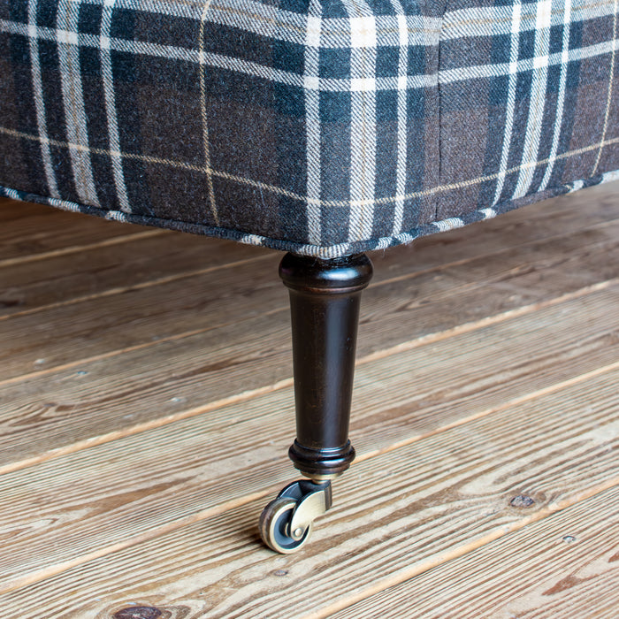 Rustic Plaid Chair with Rolled Arms and Antiqued Brass Casters, Leg Detail View