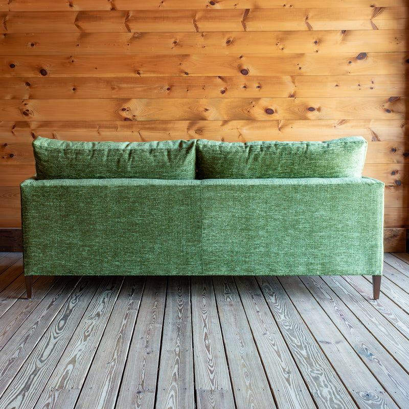 Plush Green Sofa With Roll Pillows Back View