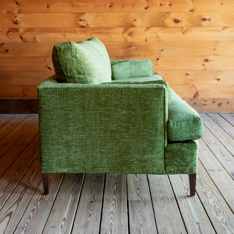 Plush Green Sofa with Roll Pillows, Profile View