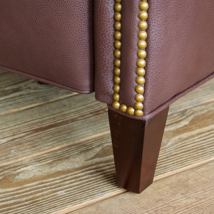 Leg close-up of a dark brown leather recliner