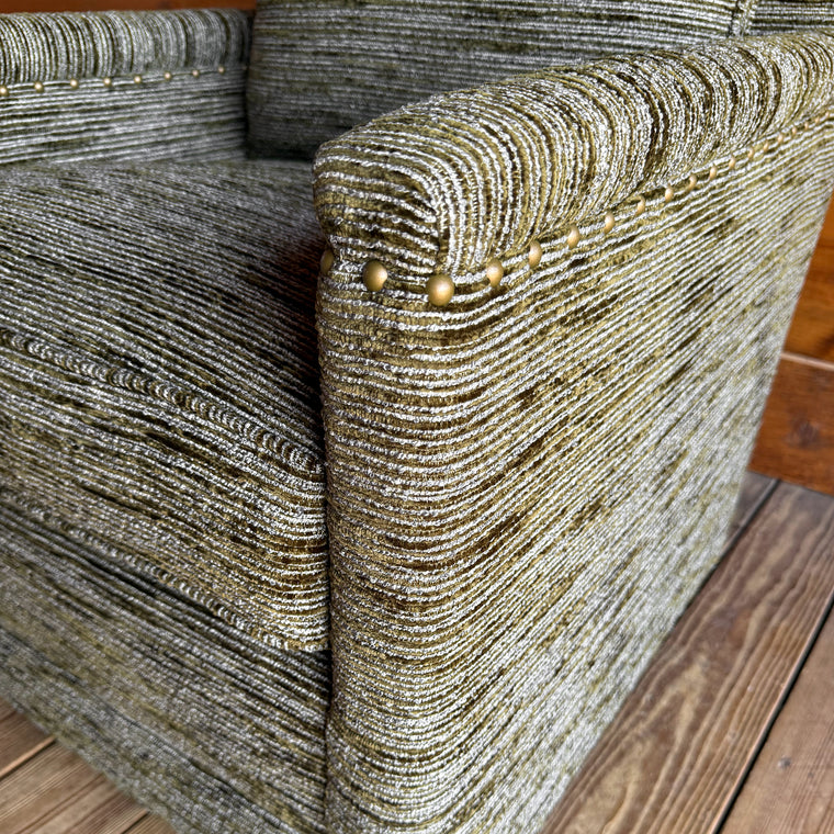 Close-up of a mottled moss green upholstery fabric