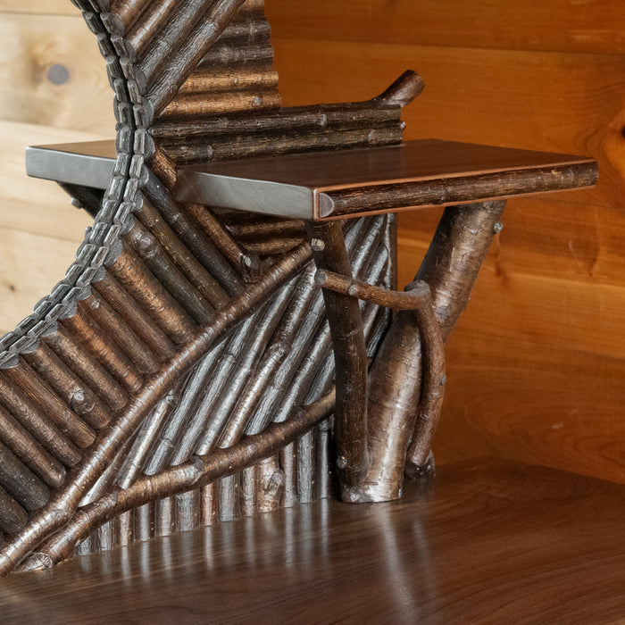 Close-up view of the display shelf of an Adirondack style mosaic sideboard against a rustic wooden wall