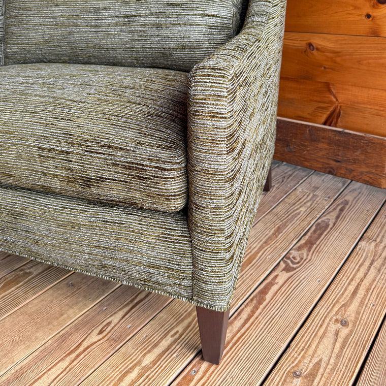 Close-up of a mottled moss green upholstery fabric