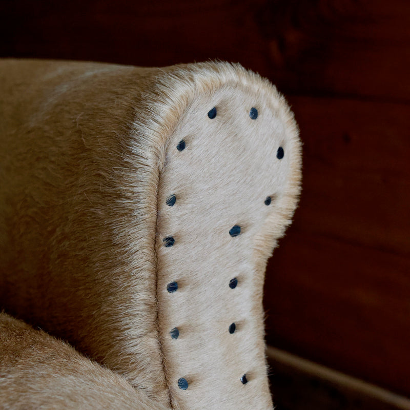Cowhide Arm Chair with Cut Nail Trim and Wooden Legs