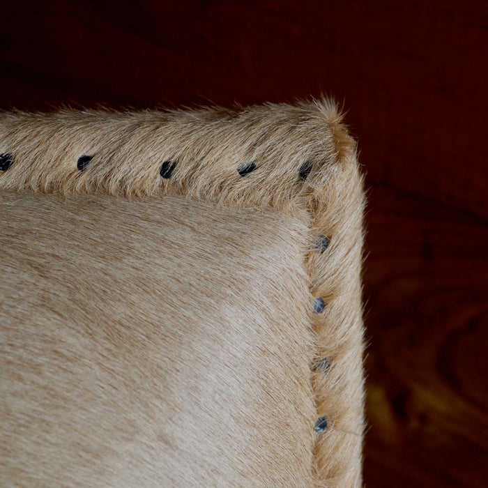 Cowhide Arm Chair with Cut Nail Trim and Wooden Legs