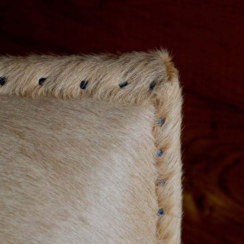 Cowhide Arm Chair with Cut Nail Trim and Wooden Legs