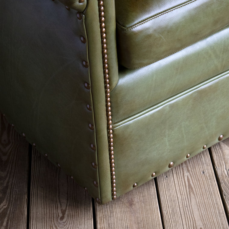 Rustic Green Leather Swivel Chair with Rolled Arms and Decorative Nailhead Trim